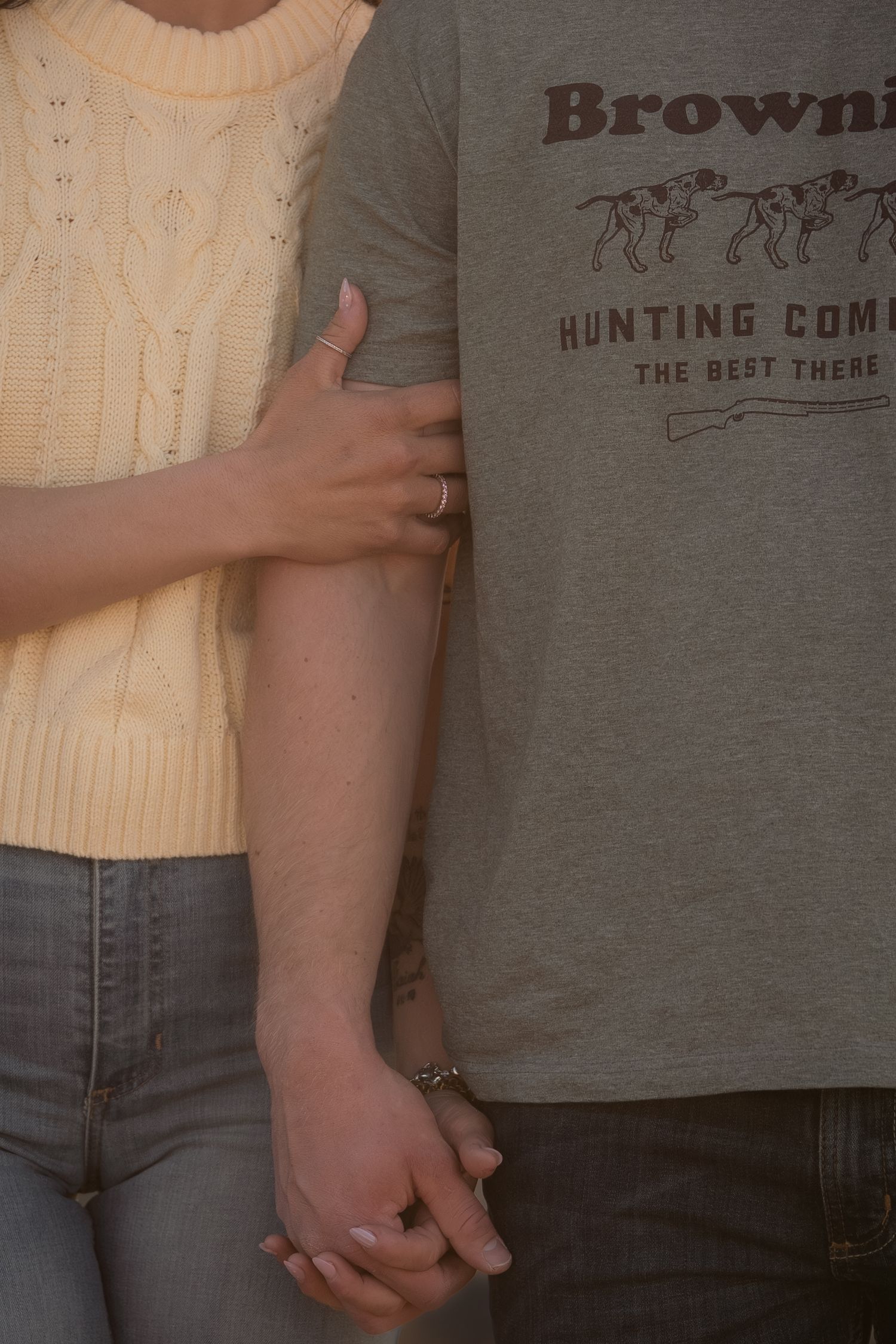 Intimate golden hour couple portrait with hand-holding detail, Arizona desert photography.