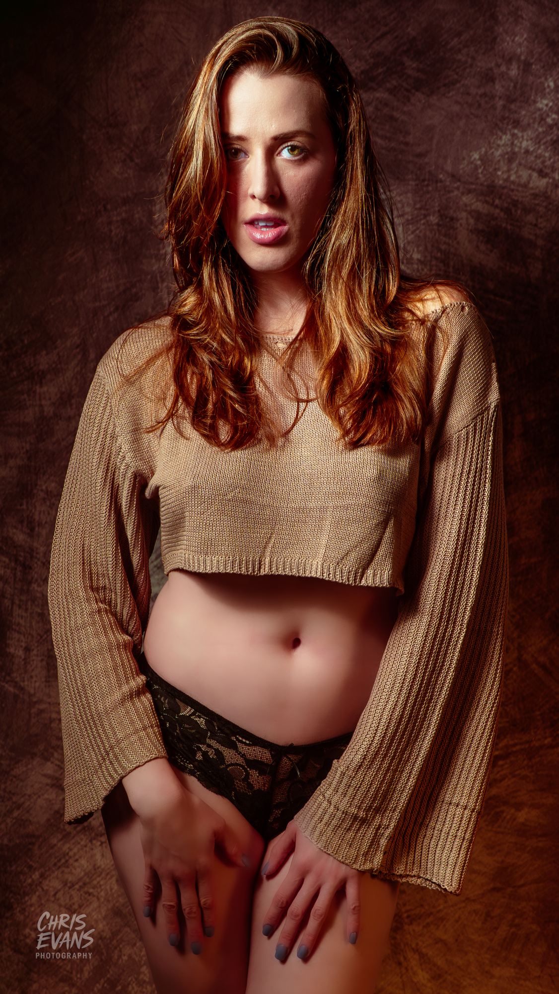Artistic boudoir photo series showing model in tan sweater against dark textured background.