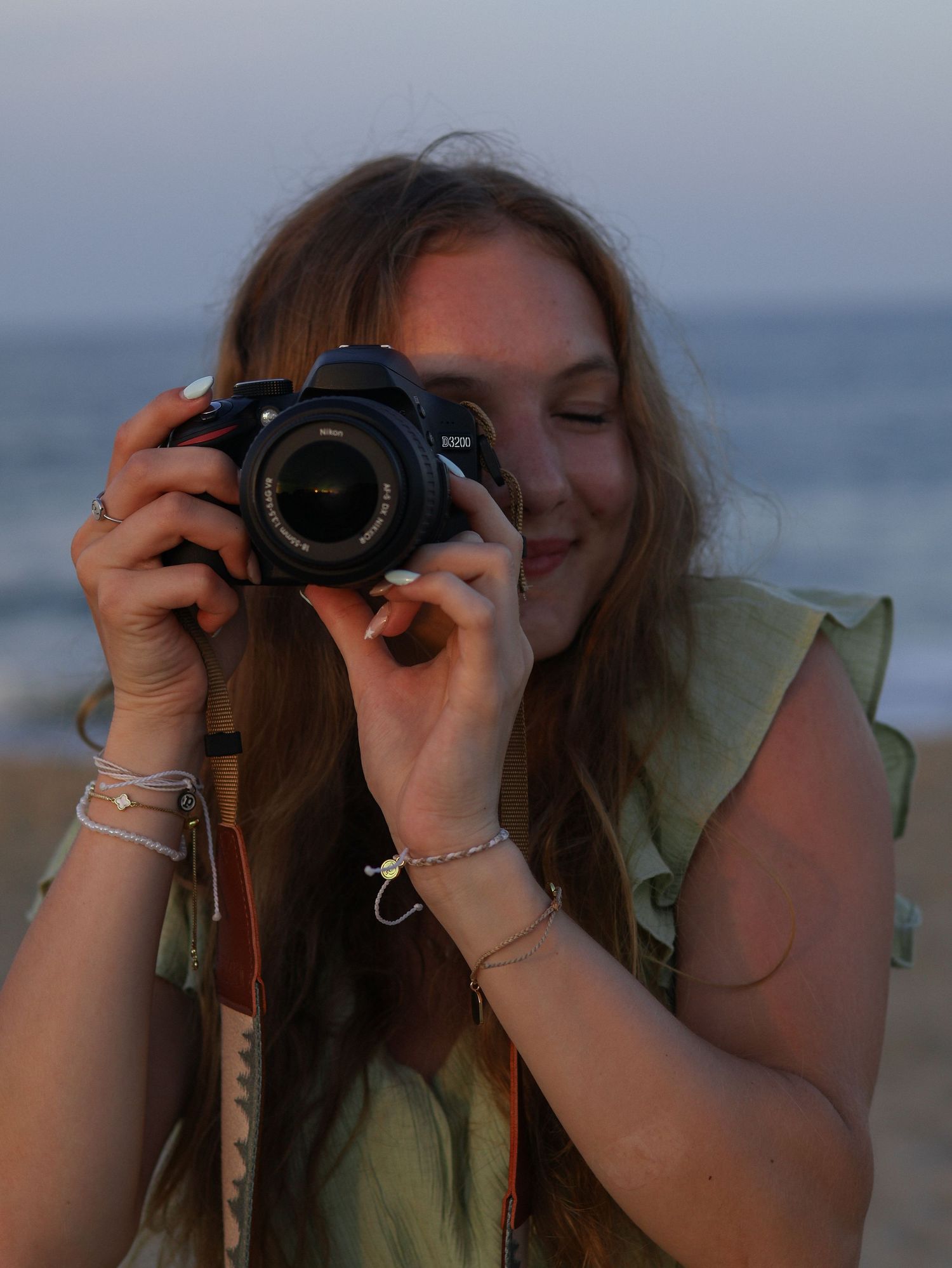 photographer holding camera in front of face