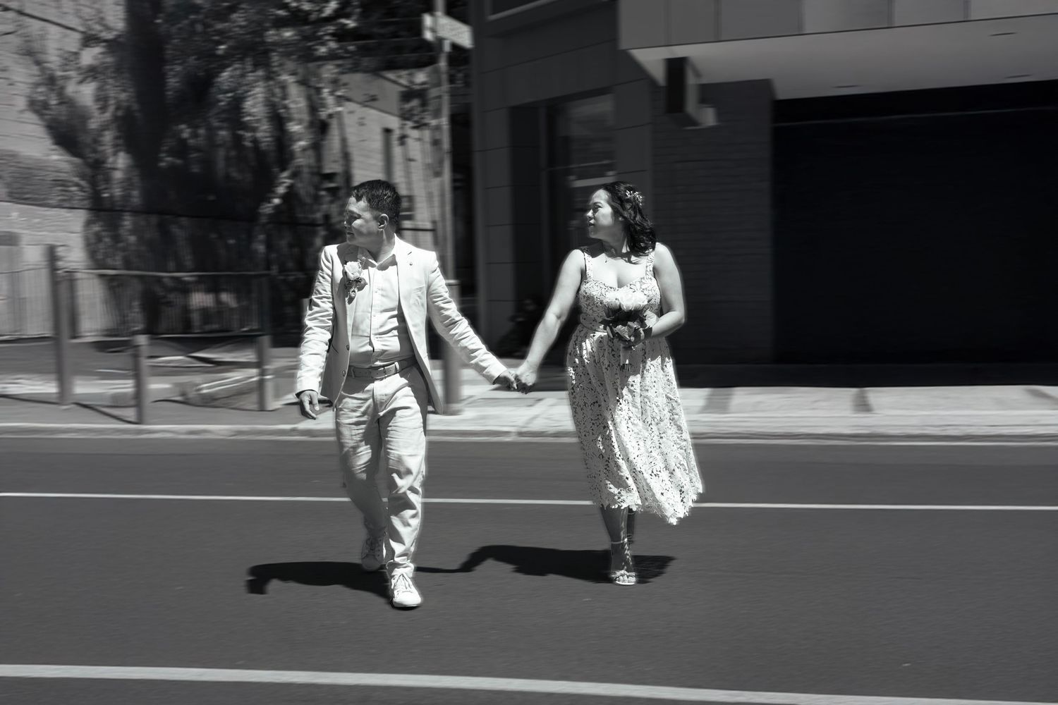 Newlyweds crossing a busy road in Adelaide city center after their ceremony