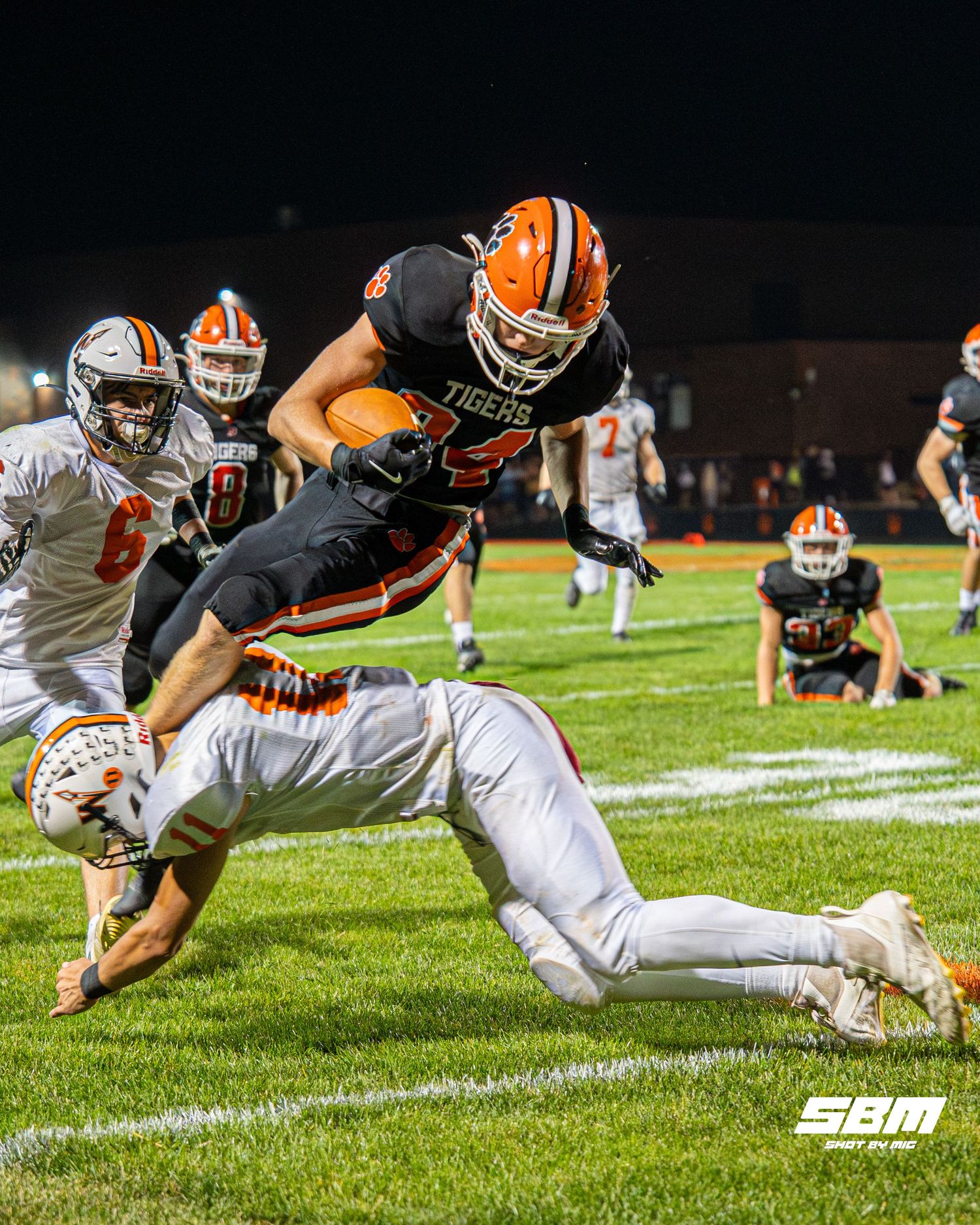 Byron's Landon Bonvallet hurdles over Winnebago's Kaeden Langhoff during their 55-7 win over Winnebago.