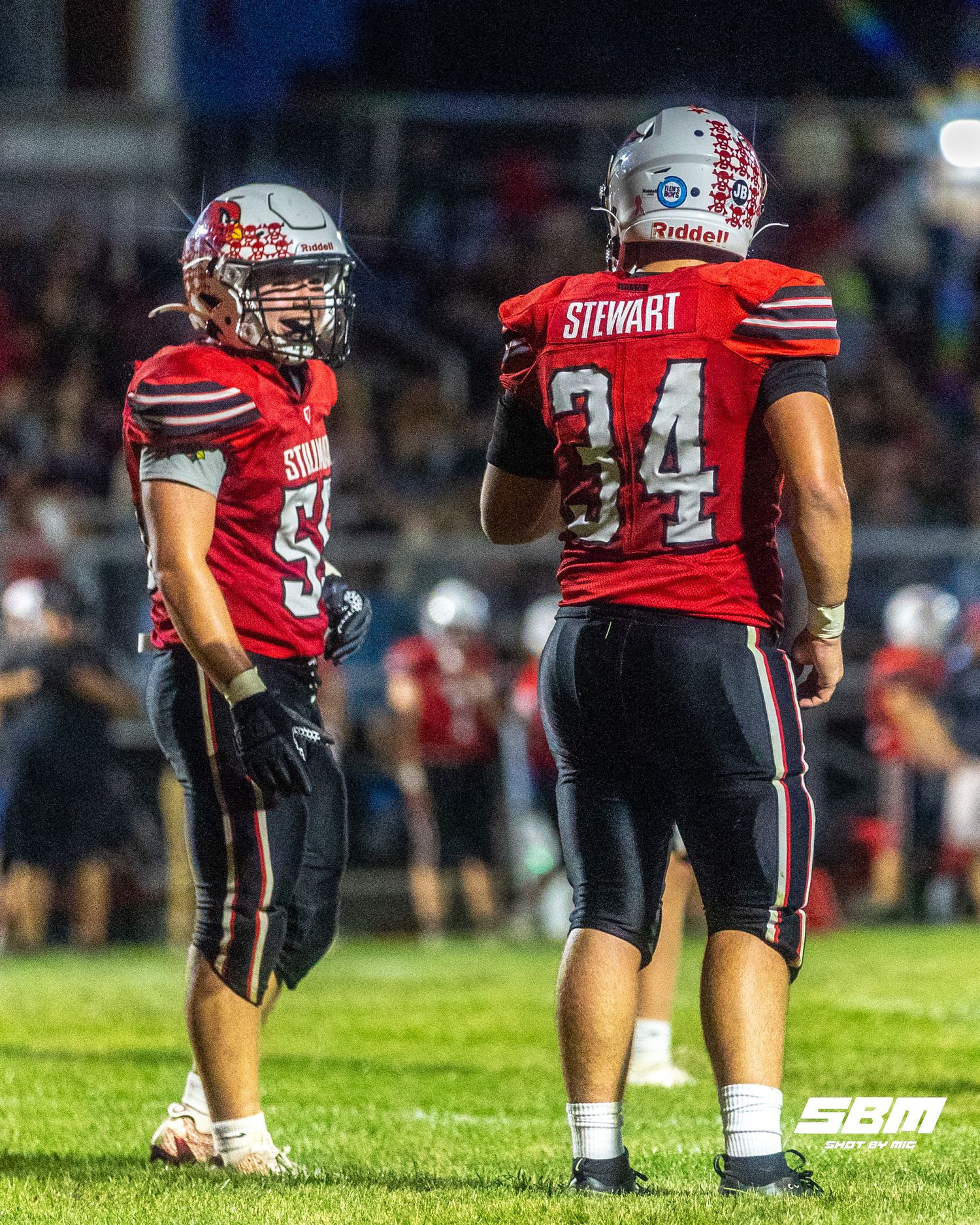Stillman Valley's Wyatt Birkett (55) & Brady Stewart (34) talk about the next move on the defense during their 50-20 win over Lutheran.