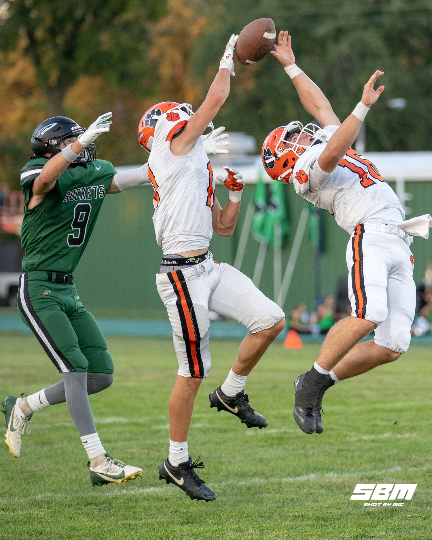 Byron's Andrew Talbert (16) & Weston Auker (11) attempt to intercept the ball during their 63-0 win over Rock Falls.