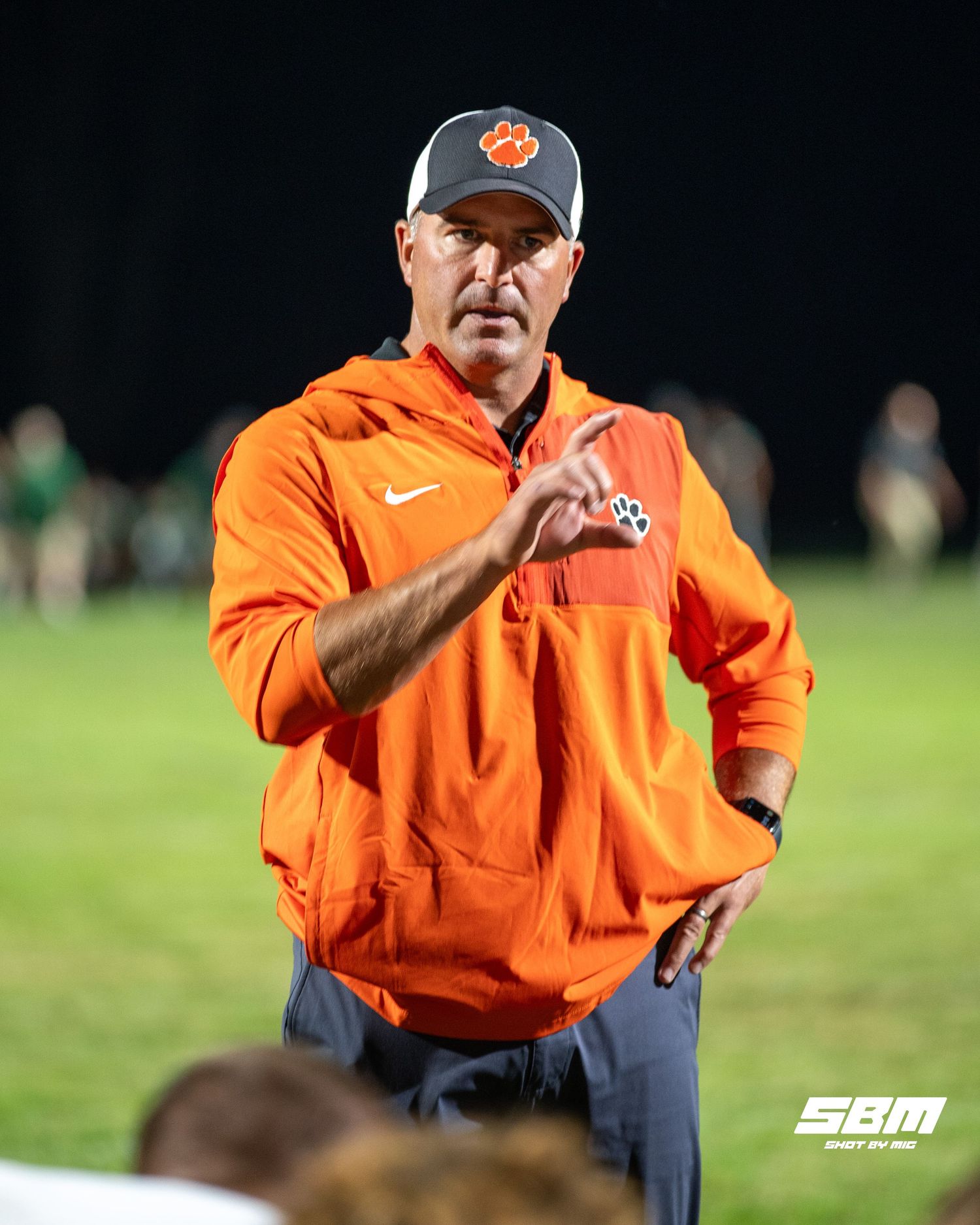 Byron's defensive coordinator Sean Considine is giving his players a speech after their 63-0 win over Rock Falls.