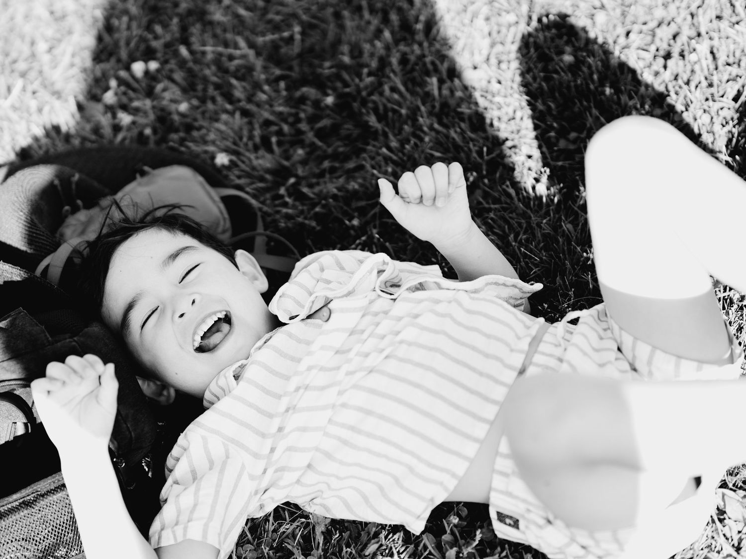 Black and white photo of a child laughing.