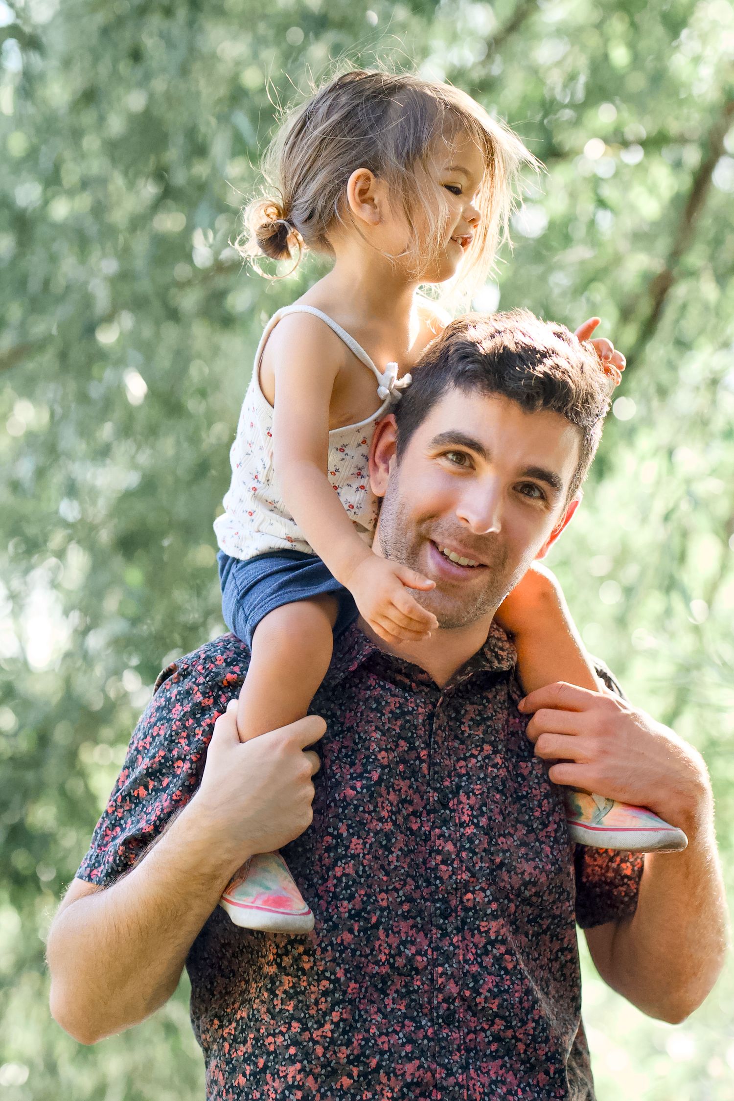 A portrait of a father and daughter outdoors by the Poudre River in Fort Collins, Colorado.