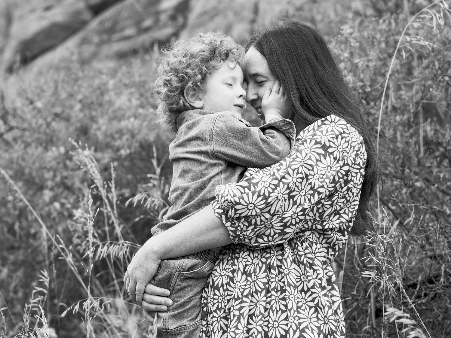 An intimate black and white portrait of a mother and son embracing at Lory State Park.
