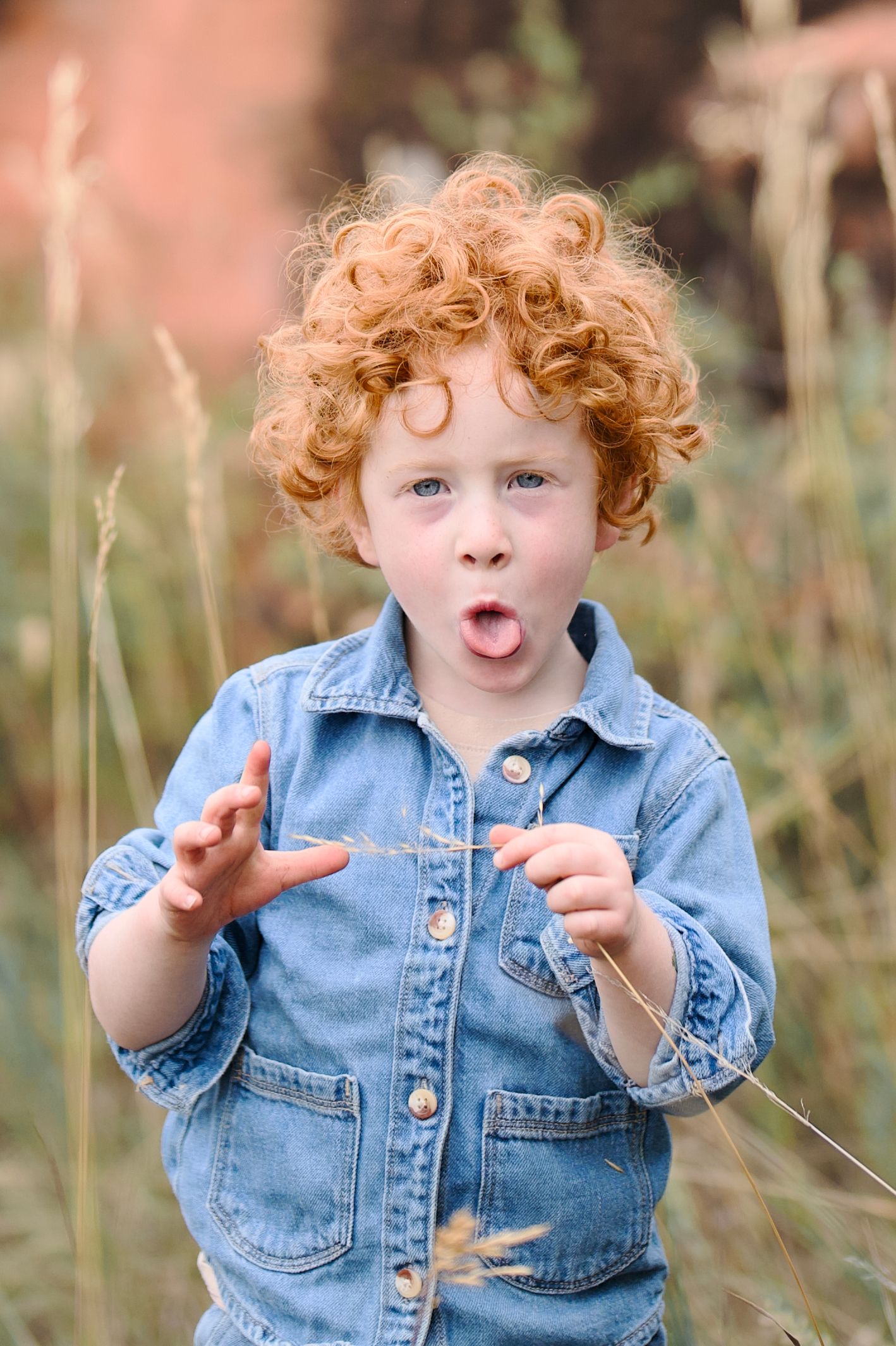 An outdoor portrait of a three year old red-headed boy being silly. Taken at Lory State Park near Bellevue or Fort Collins, Colorado.