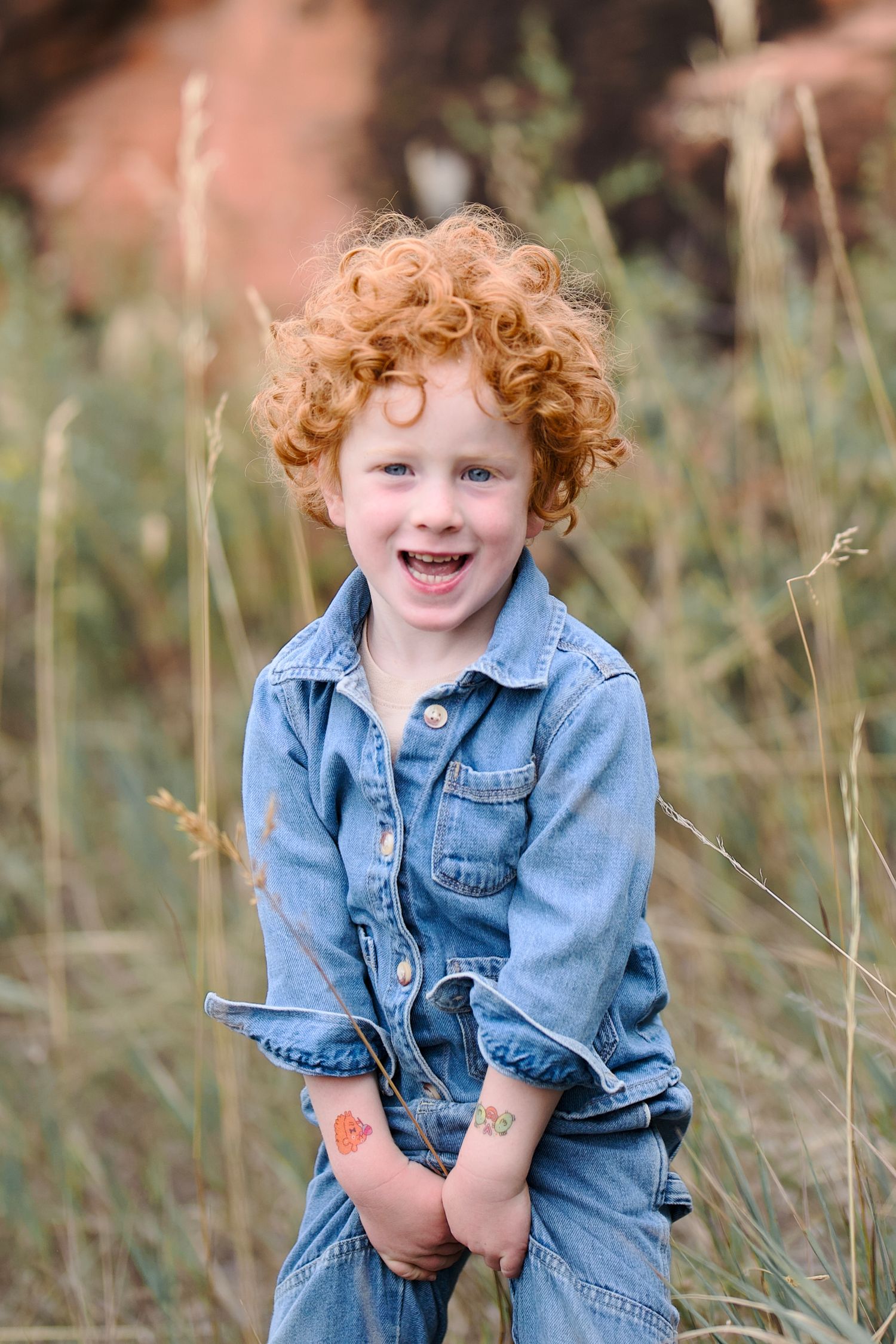 An outdoor portrait of a three year old red-headed boy being silly. Taken at Lory State Park near Bellevue or Fort Collins, Colorado.