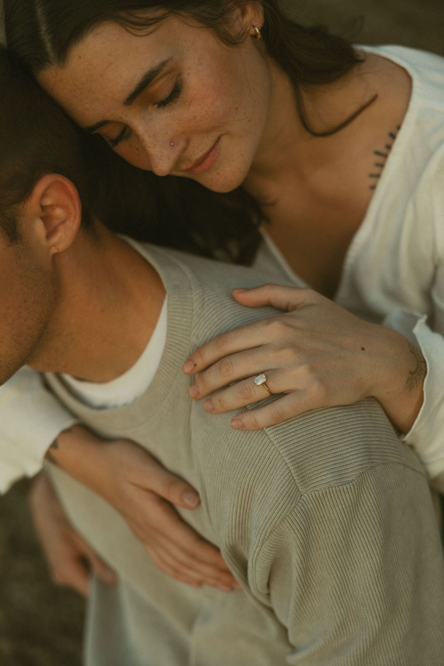 A series of intimate photos showing someone wearing a gray sweater in warm, moody lighting.