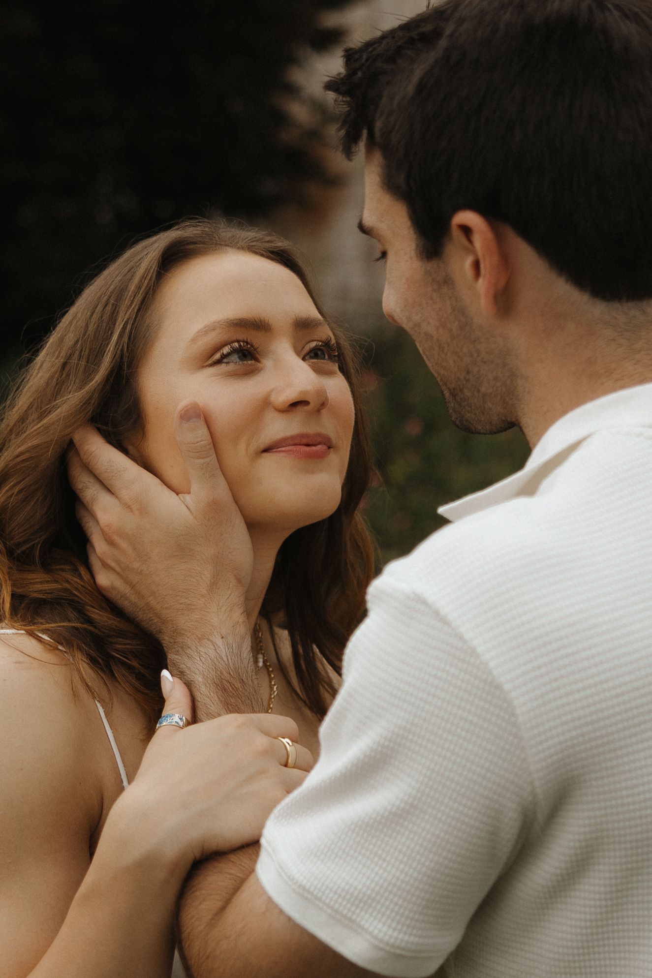 A tender moment between a couple in love as they share an intimate embrace outdoors at golden hour.