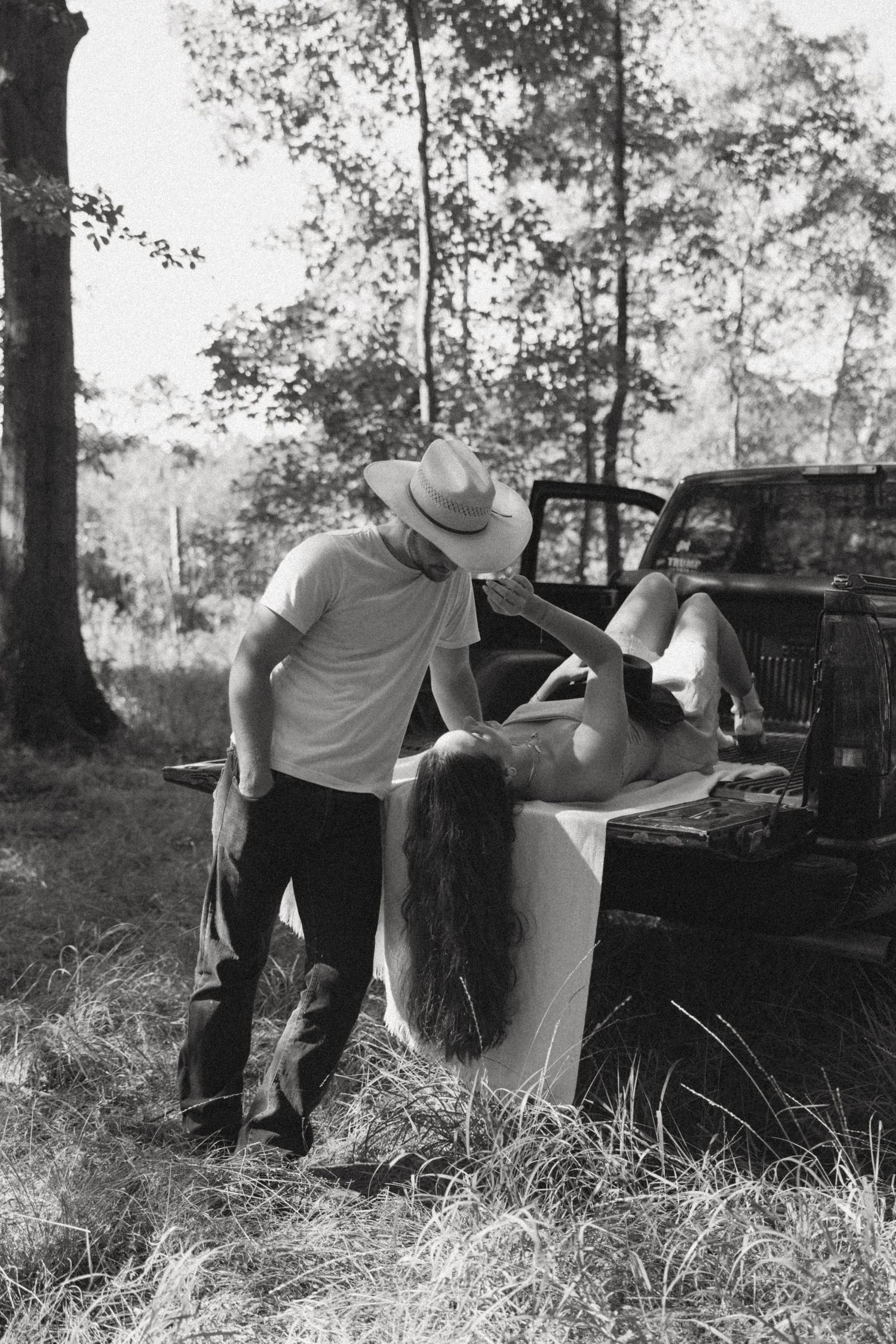 A sequence of black and white photos shows a couple dancing together in an outdoor setting among trees.