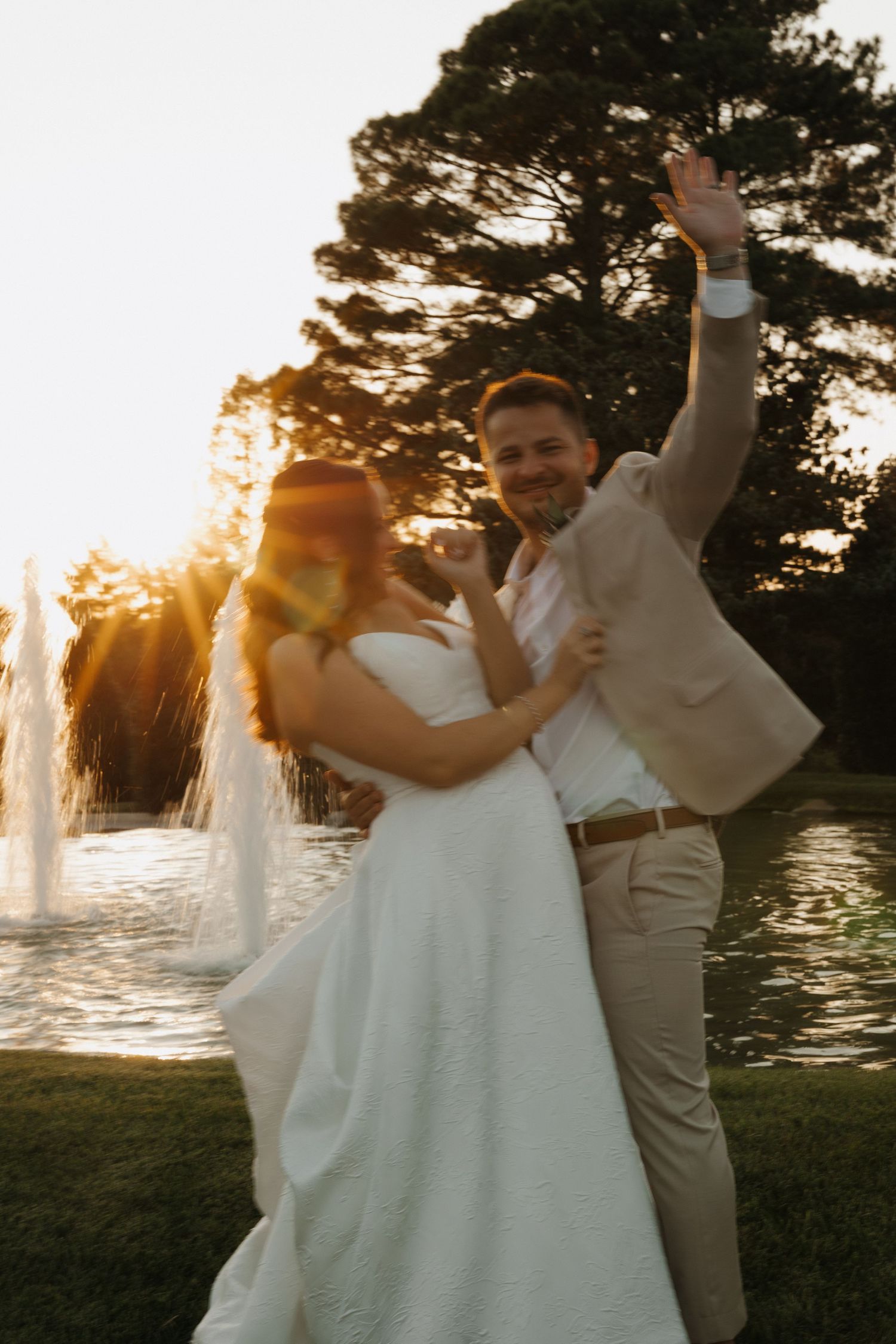 A couple dances and celebrates at sunset during their waterfront wedding ceremony.