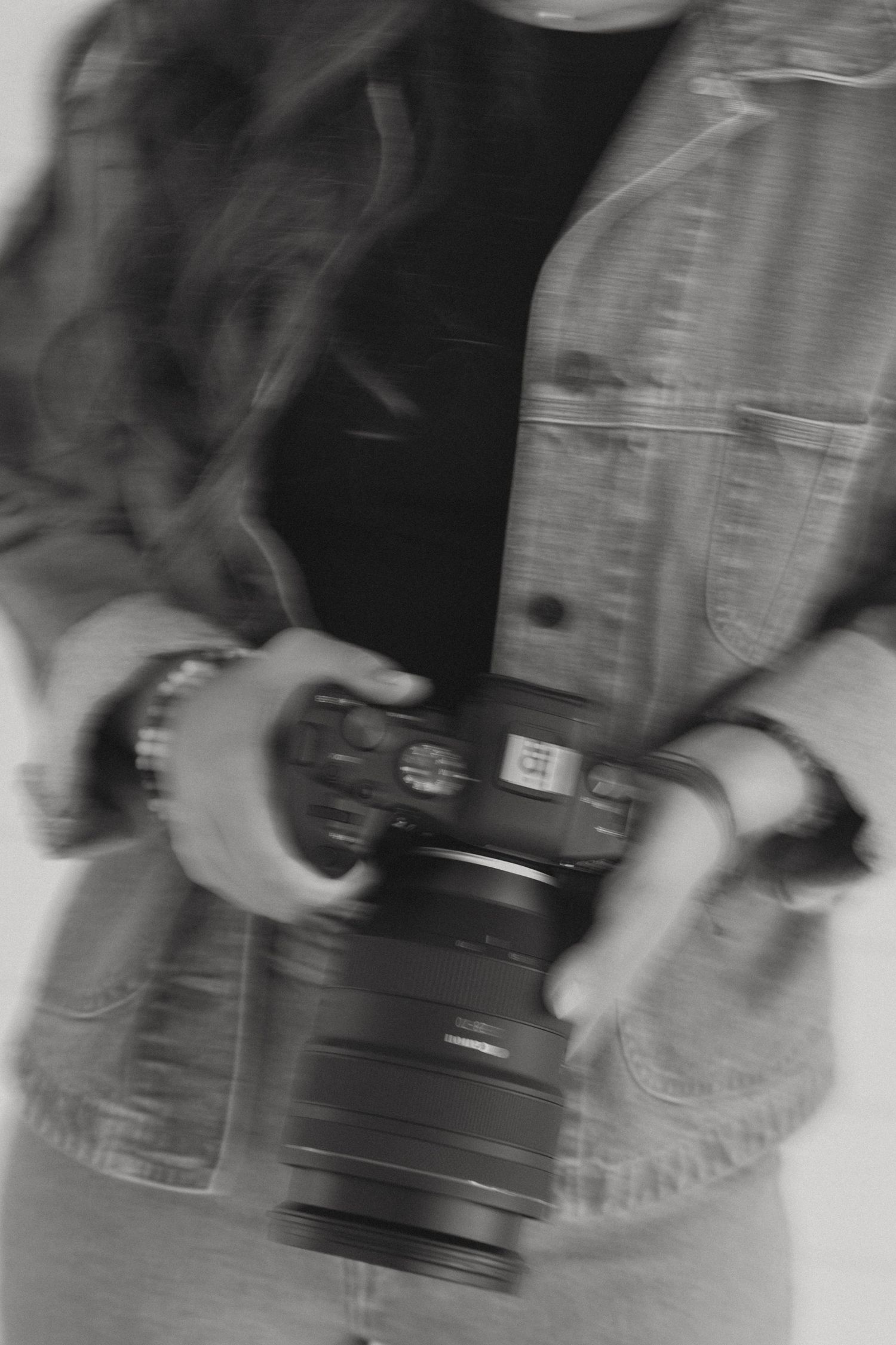 Blurred black and white camera lenses arranged in a row creating an artistic abstract pattern.