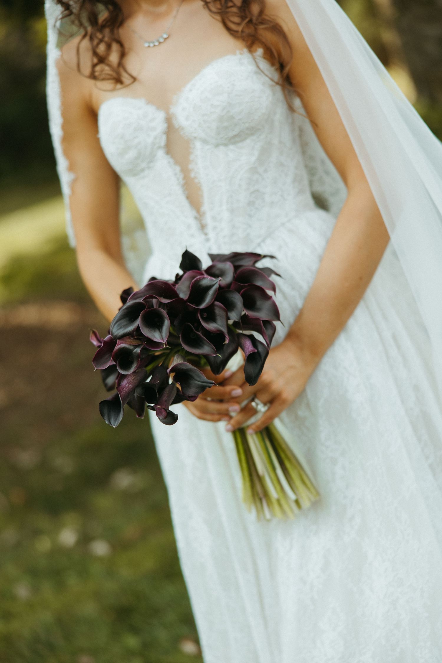 Close-up series of a white lace wedding dress with dark purple calla lily bouquet details.