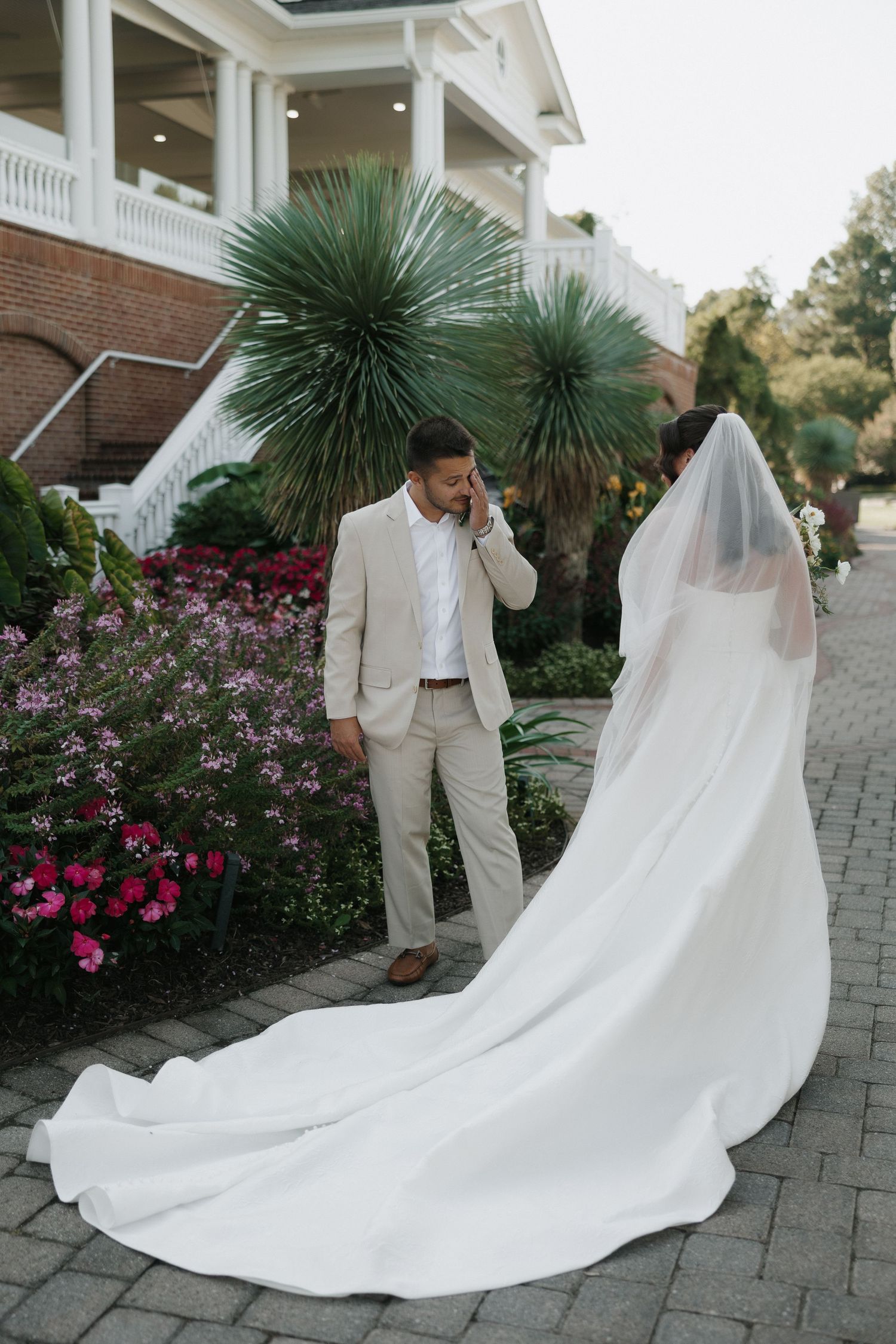 A series of wedding photos showing a long white bridal train flowing across stone pavers amidst blooming pink flowers.