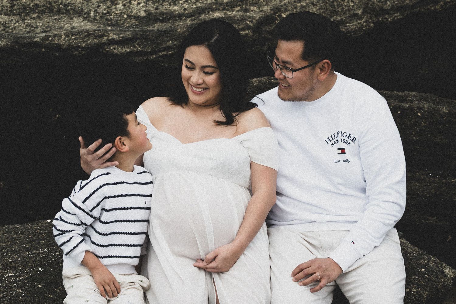 A couple in white outfits share tender moments in a series of romantic outdoor photographs.