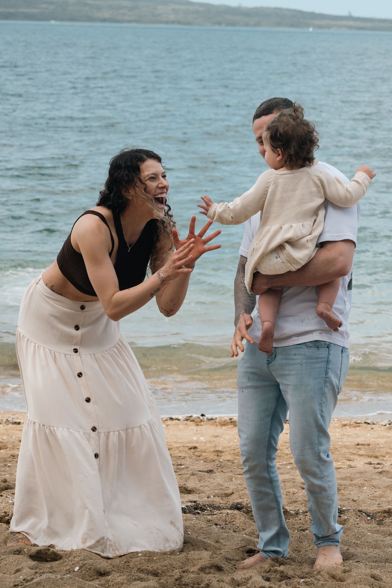 A playful sequence of photos showing two people having fun and interacting on a sandy beach with ocean in background.