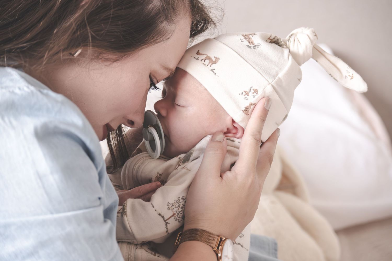A series of romantic photos showing a couple in intimate poses with soft lighting and neutral tones.