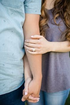 A series of four photos showing hands clasped together in an intimate embrace against light blue and gray clothing.