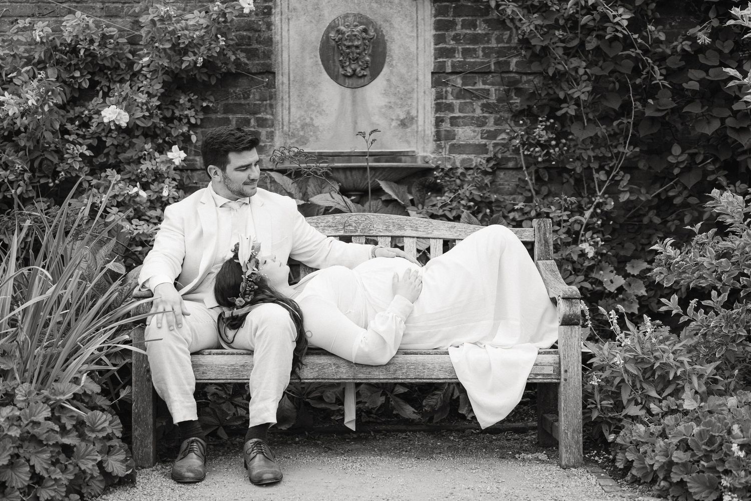 A series of five black and white photographs showing playful poses on a garden bench.