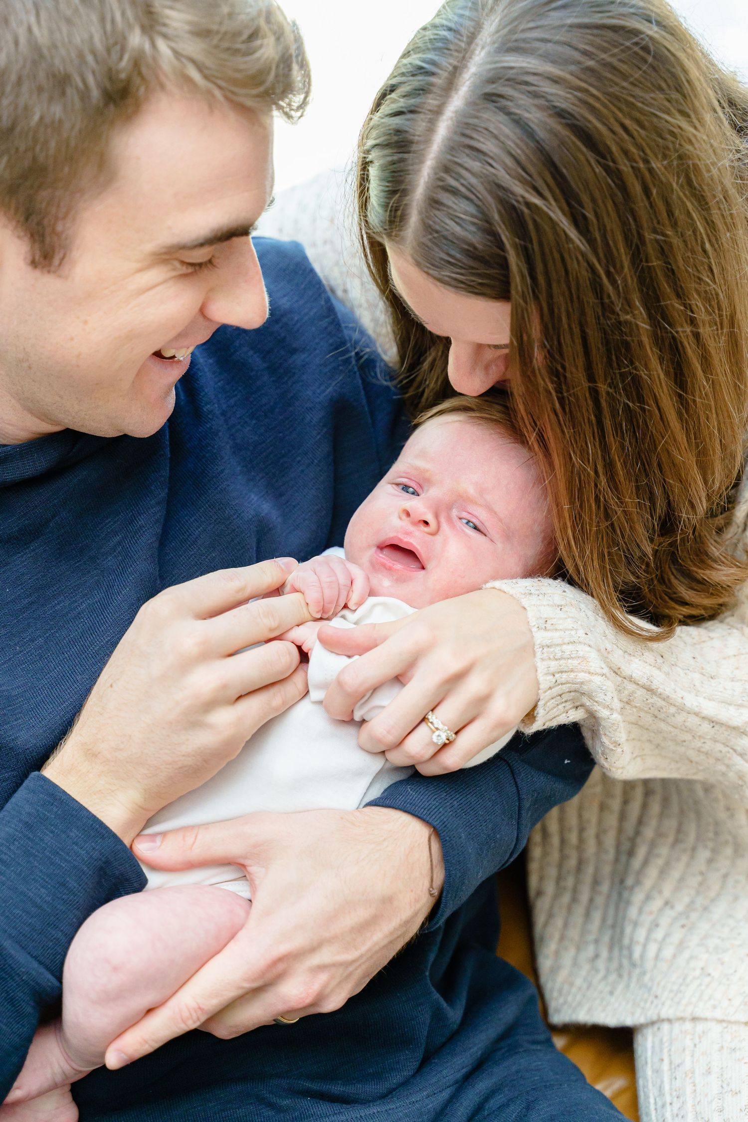 Series of color photos showing tender family moments with a newborn baby in a cozy indoor setting.