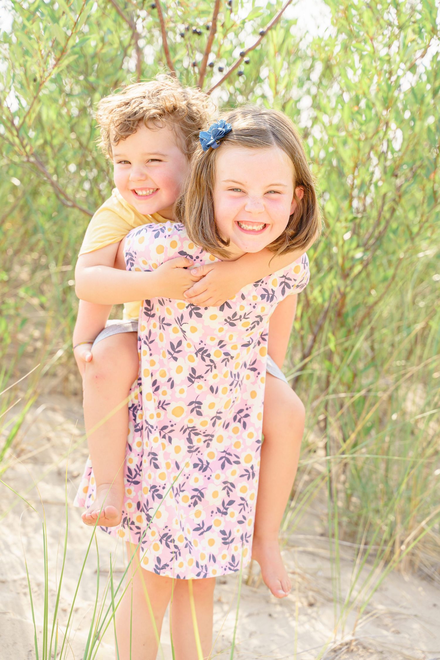 A series of candid beach portraits showing joyful moments among sand dunes and sea grass.