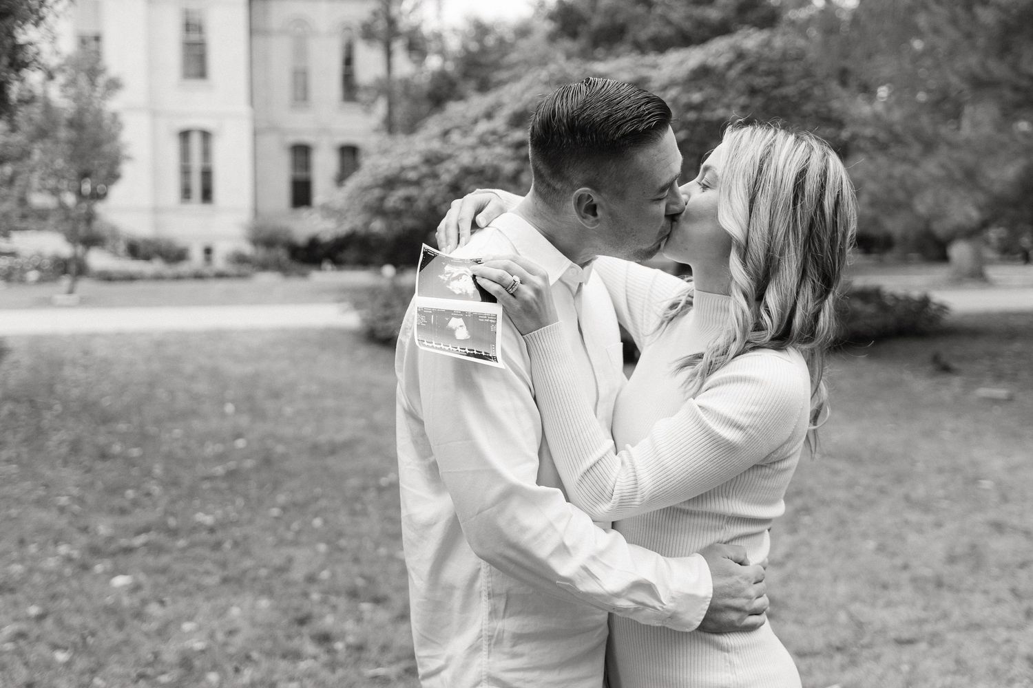 Black and white wedding photos show romantic moments between a couple dancing and embracing outdoors.