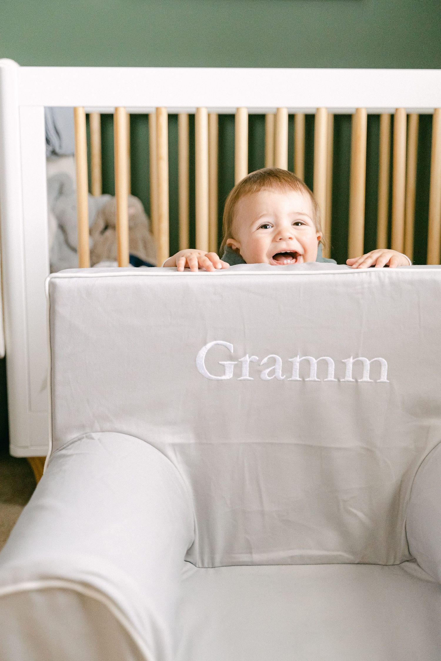 A playful scene showing someone peeking over a white couch cushion in a series of progressive shots.