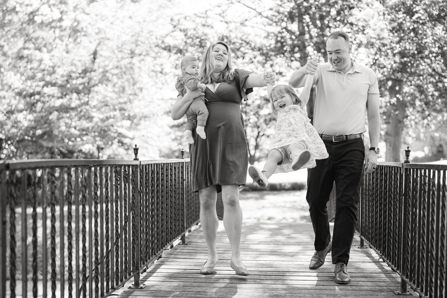 A series of black and white photos showing couples walking along a fence-lined path in a romantic outdoor setting.
