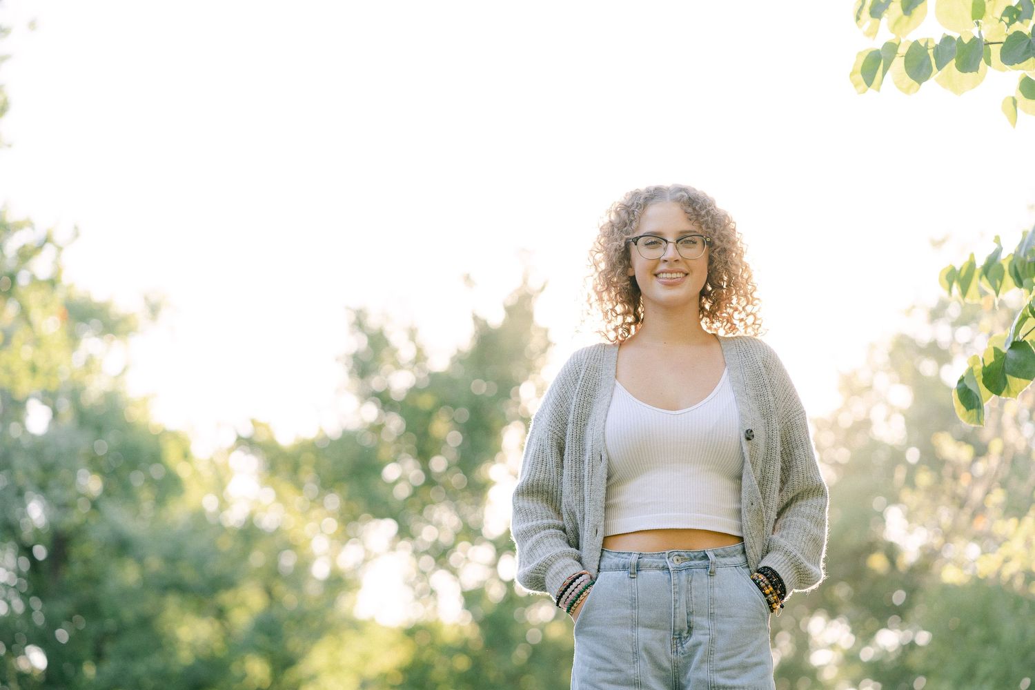 A collection of portraits taken outdoors with golden hour lighting and natural greenery in the background.