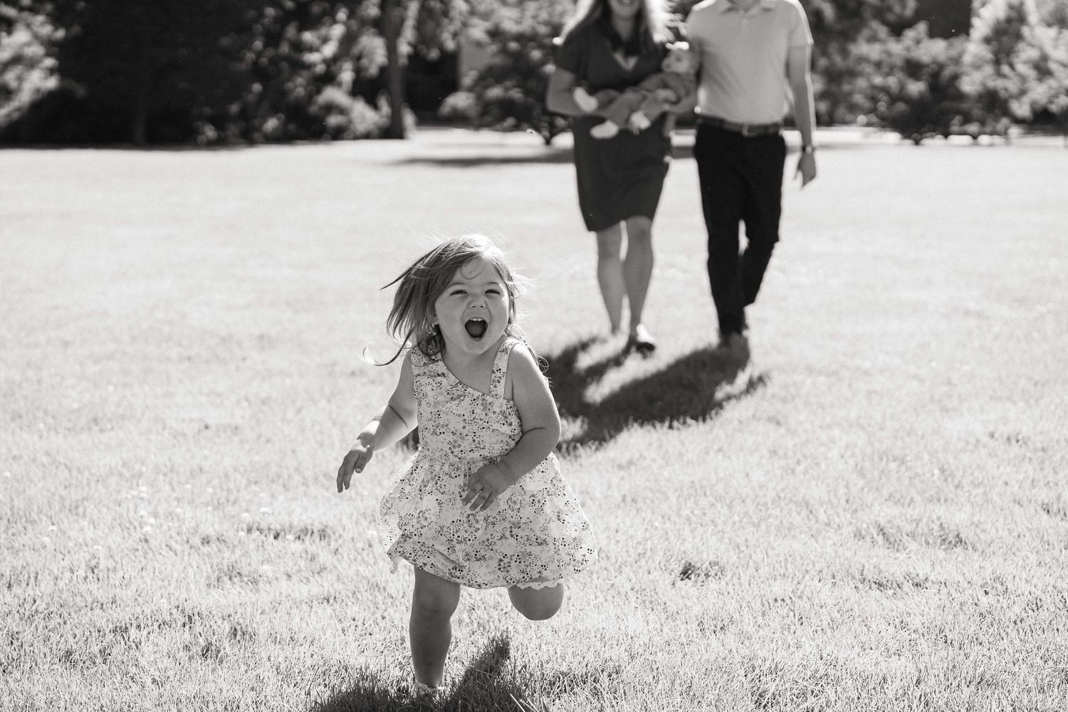 Black and white photo sequence showing a child running and falling while playing outdoors on grass.