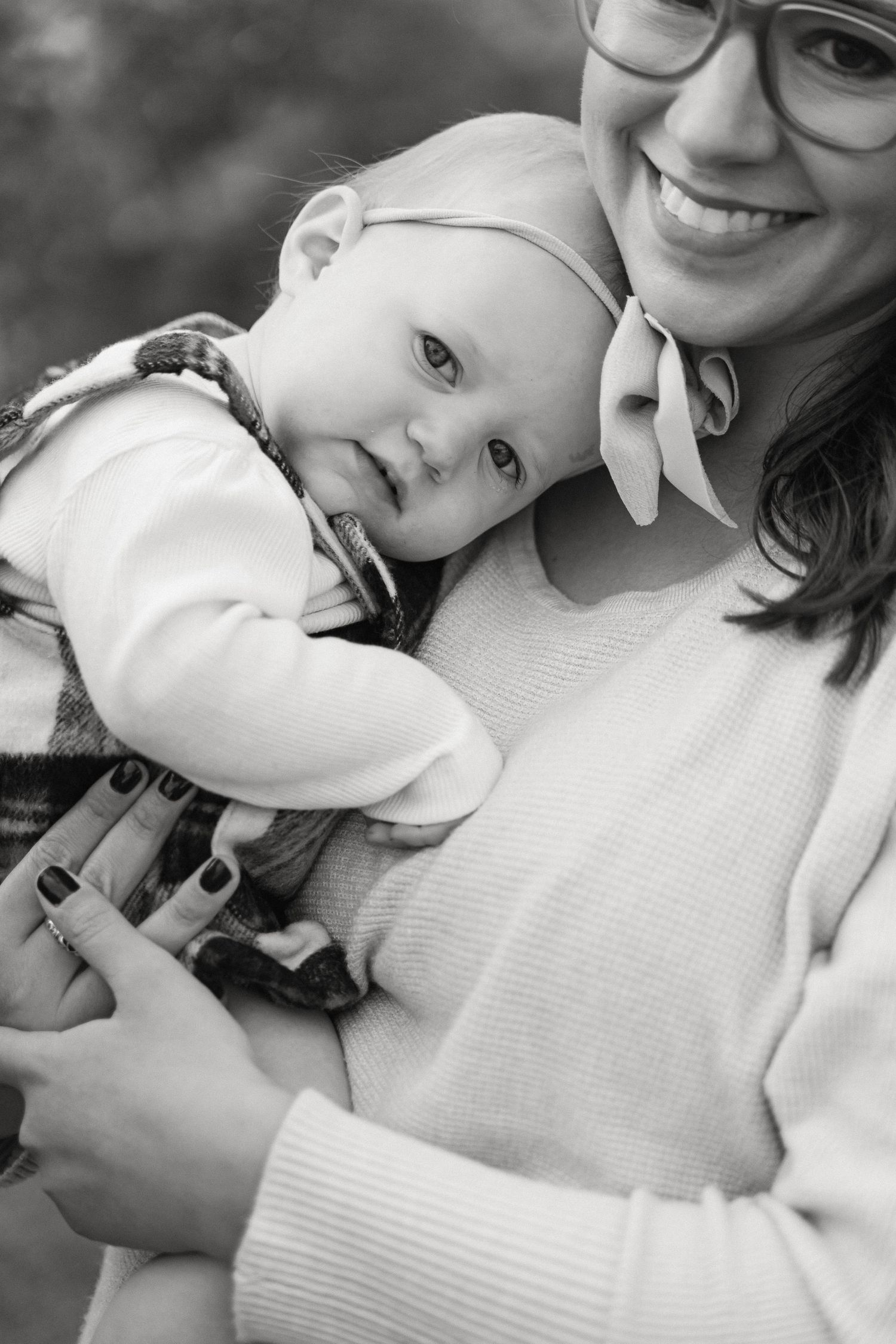 A heartwarming black and white photo series showing tender moments between parent and child in close embrace.