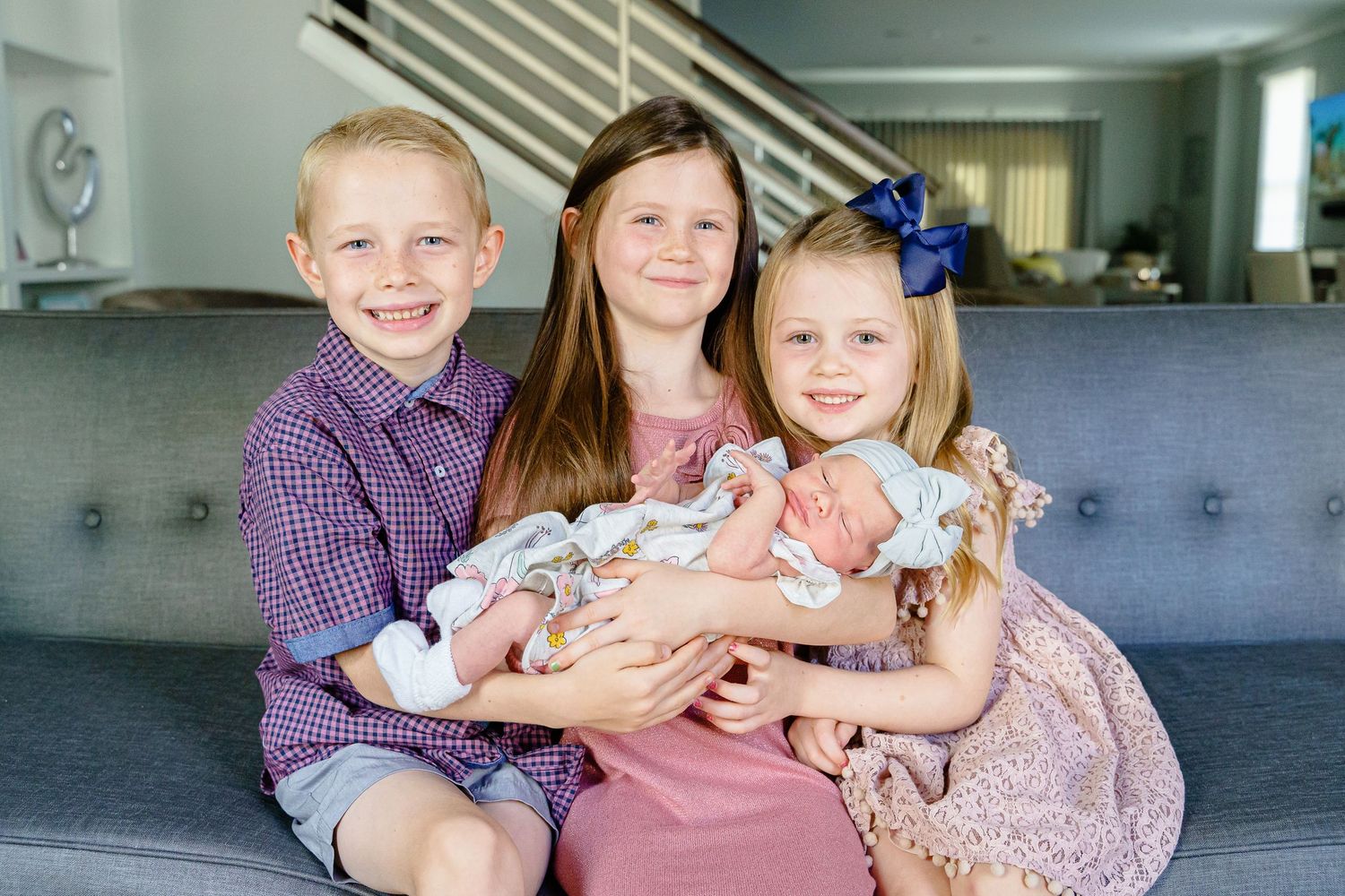 A series of five connected photos showing a family on a couch in coordinated outfits.