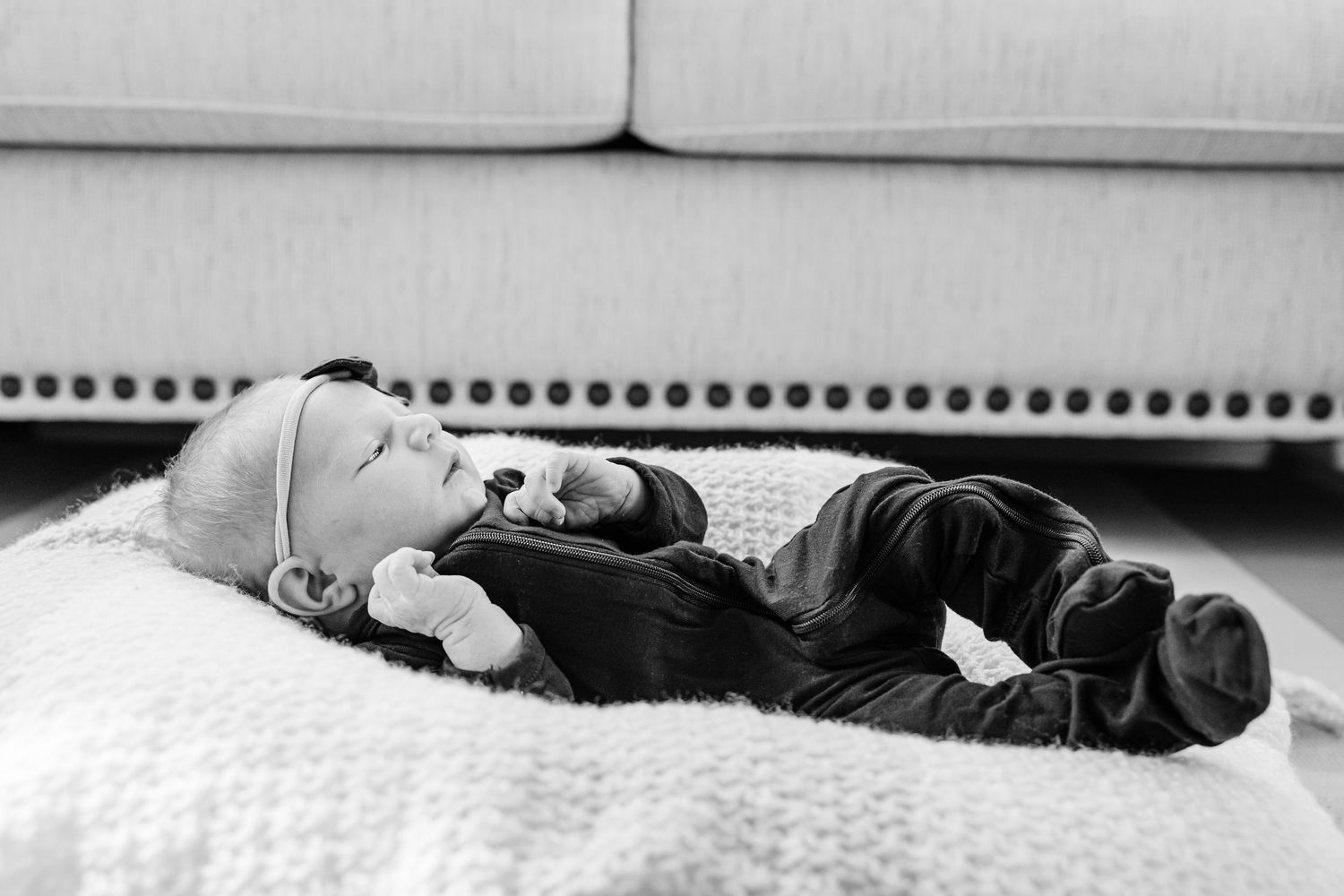 A series of black and white photographs showing someone sleeping in different positions on a bed.
