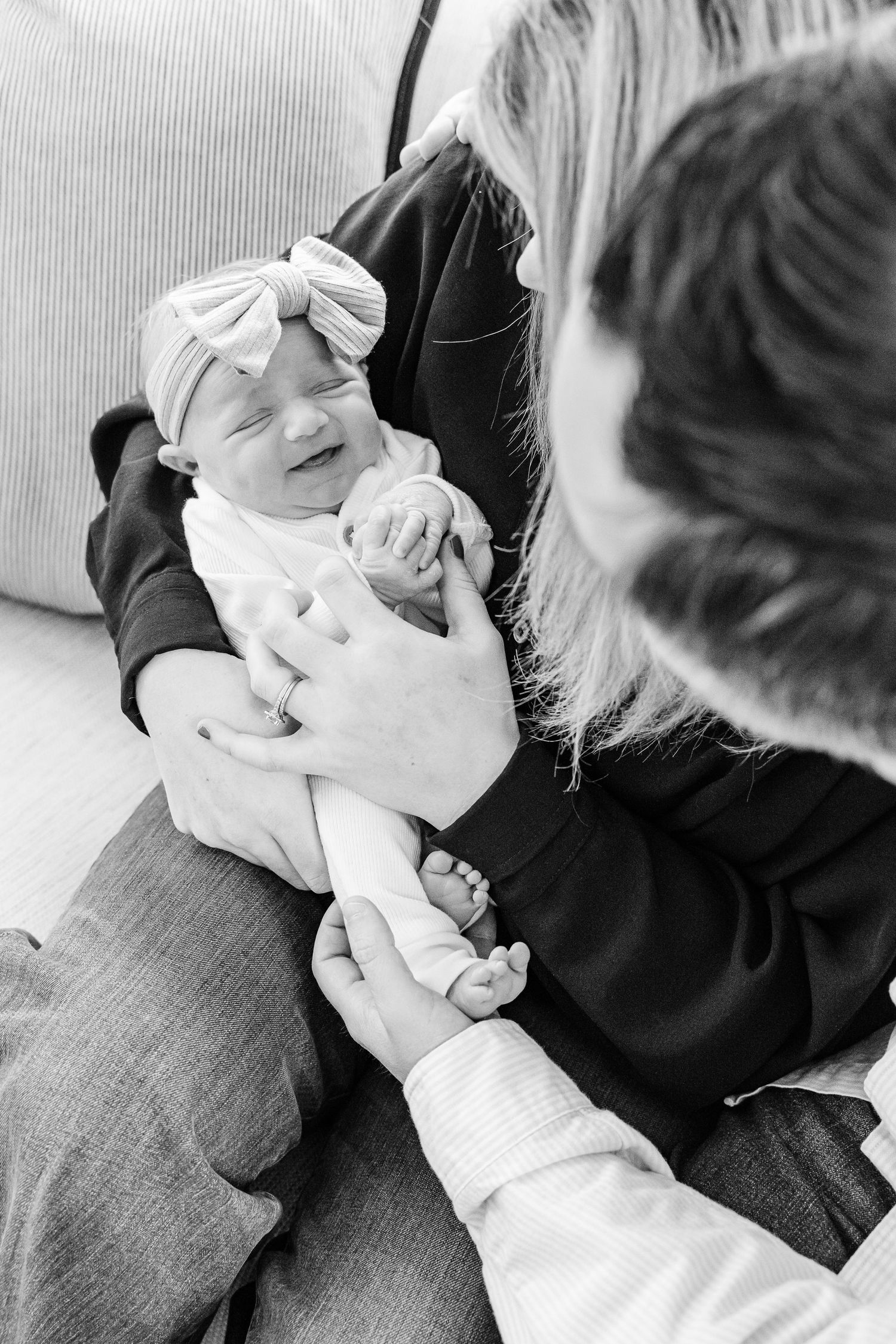 Black and white photos show a tender moment between two people cuddling together in a casual setting.