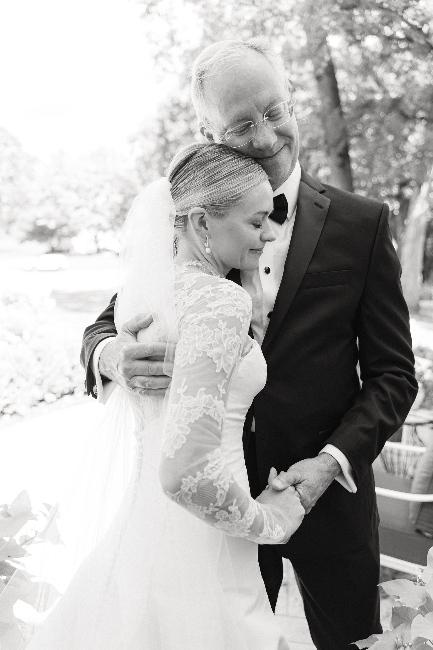 Black and white photo of a bride and groom sharing a tender embrace on their wedding day outdoors in South Bend, IN
