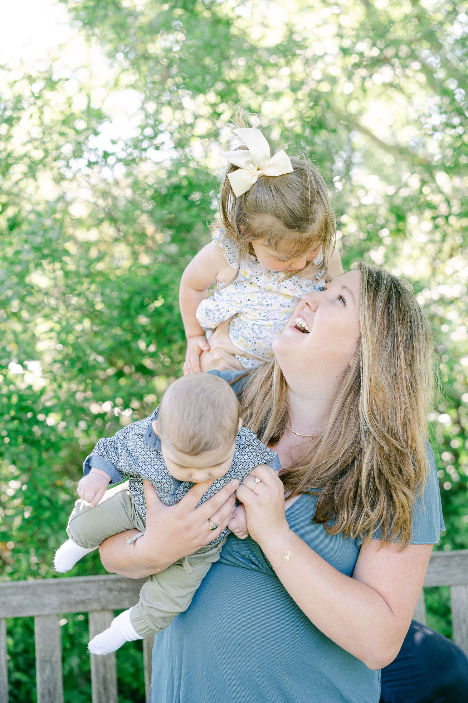 A tender moment captured as a mother and baby share loving cuddles on a sunny day.