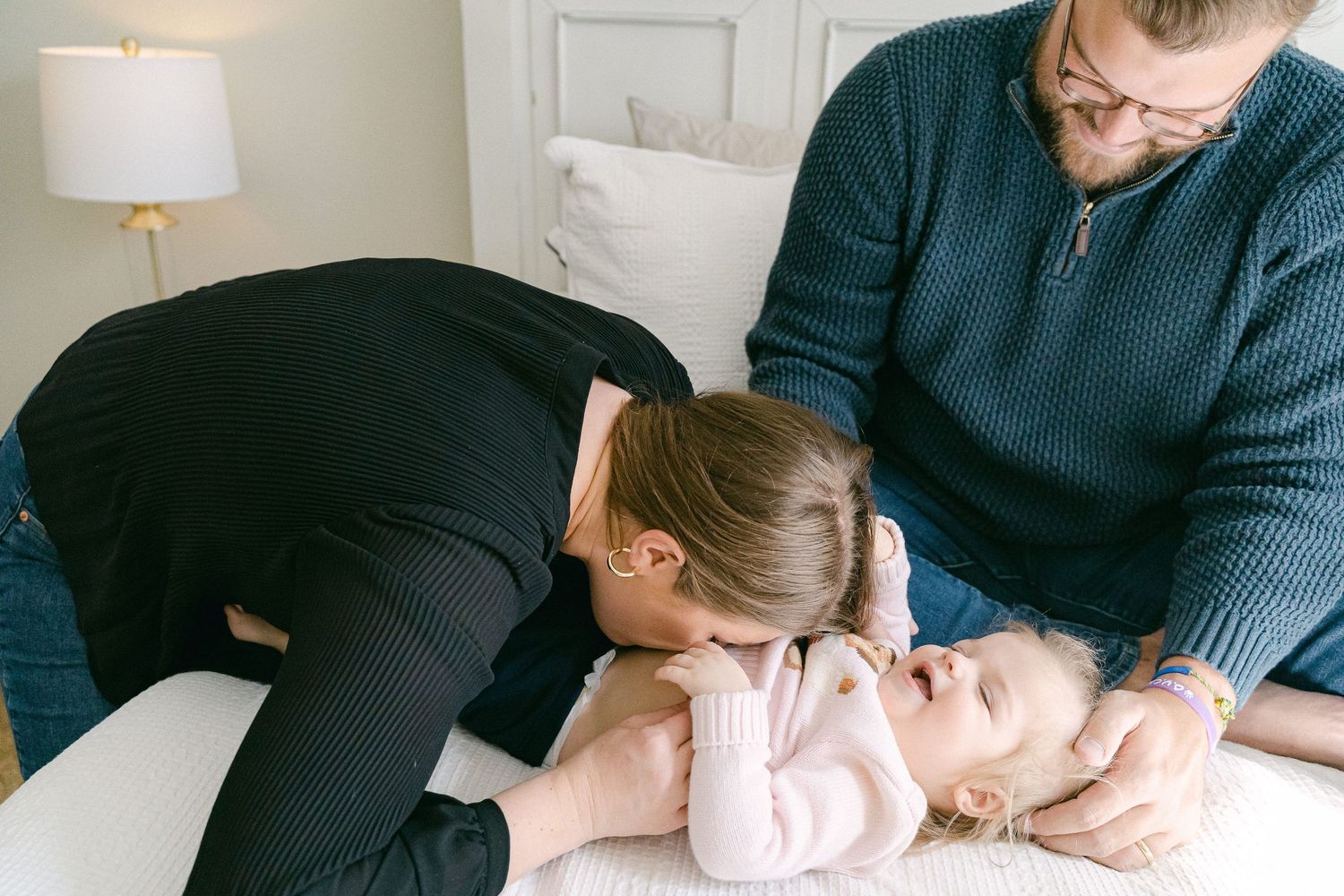 A series of photos showing a baby getting chiropractic treatment while lying on an examination table.
