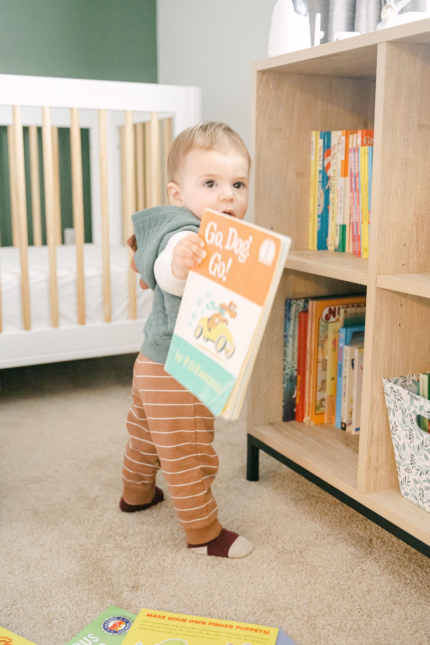A toddler explores a bookshelf in a home library, reaching for colorful children's books in a series of connected images.