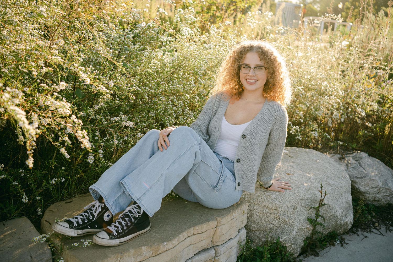 A series of images showing someone sitting on rocks in a natural outdoor setting at sunset.
