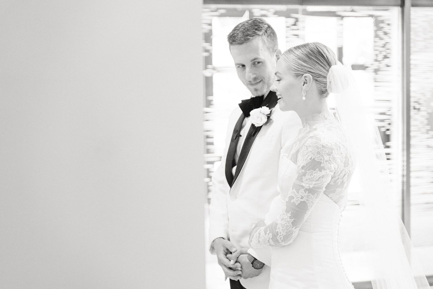 Black and white photo of a bride and groom sharing a tender moment at their wedding ceremony in South Bend, IN