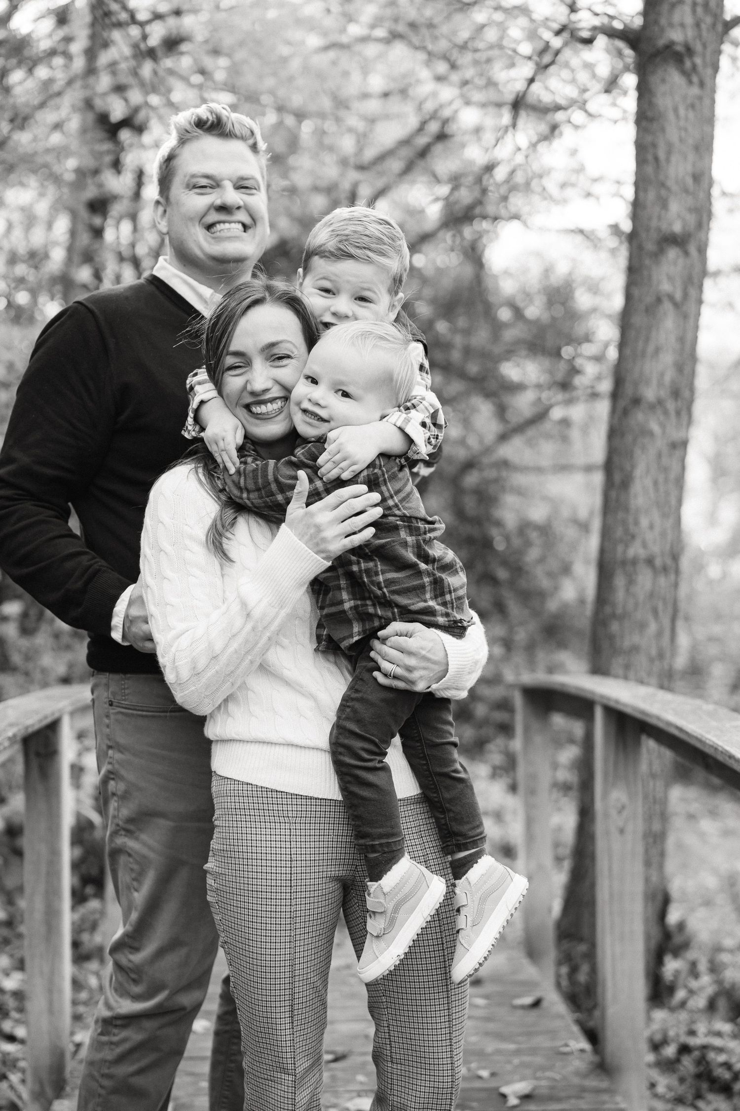 Black and white candid family photos showing joyful moments together outdoors.