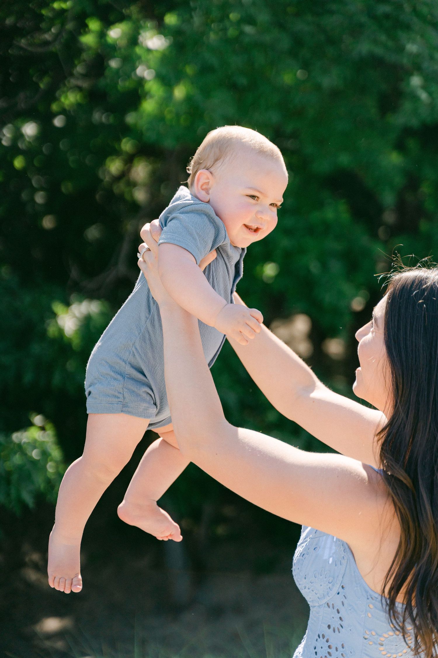 Playful outdoor scene with joyful interaction against a green leafy background.