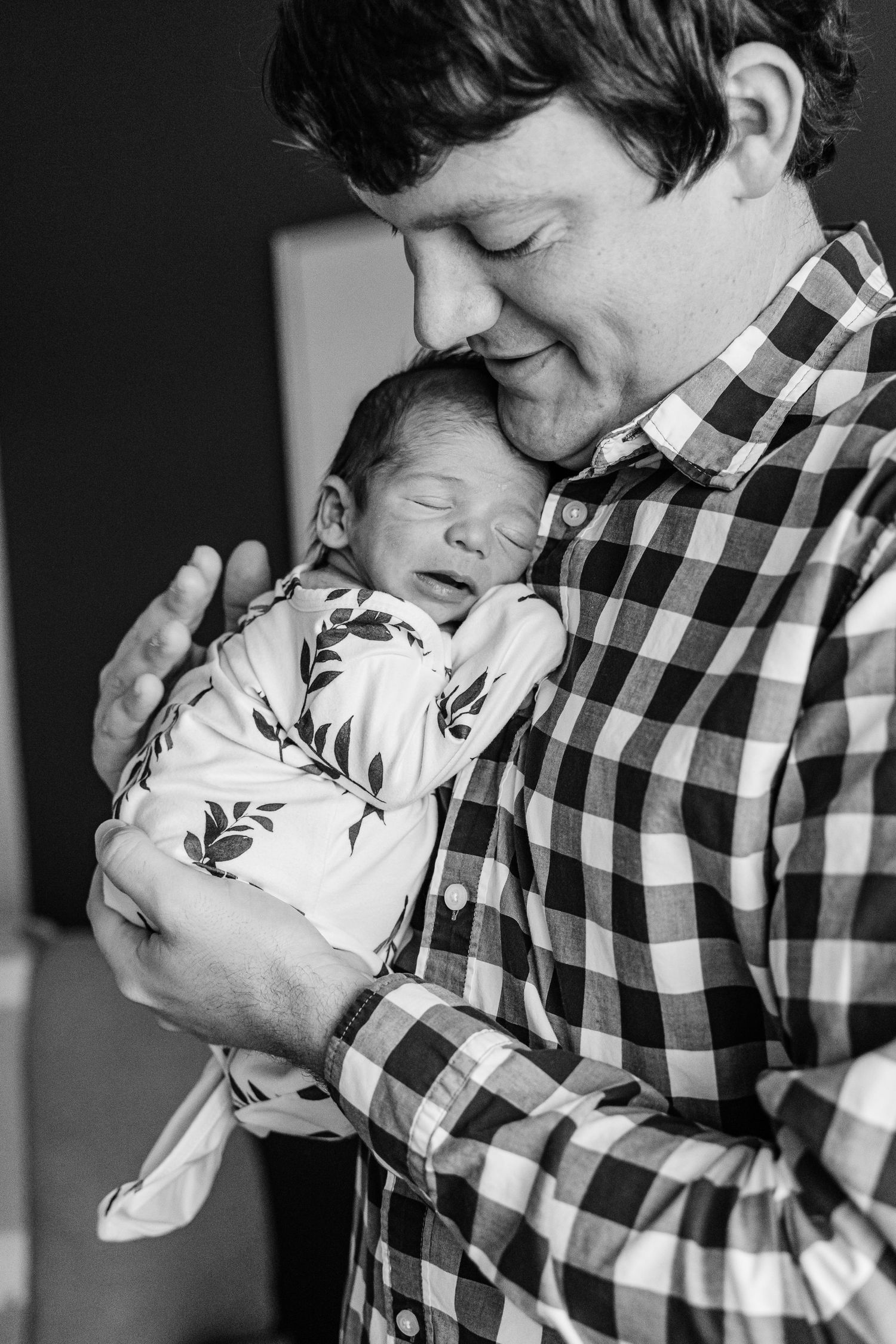 Black and white photo series showing someone in a checkered shirt holding and kissing a white rabbit.