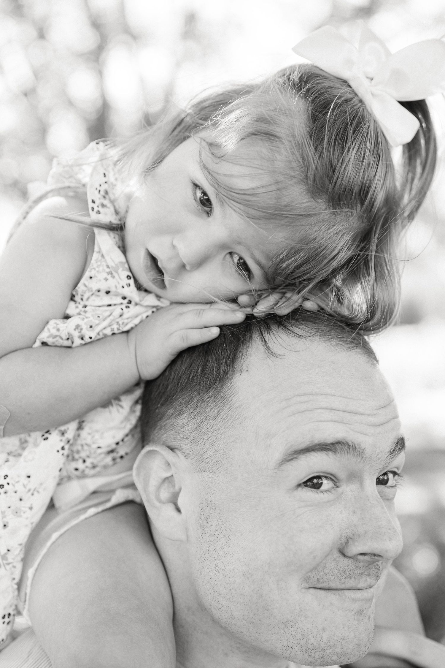 Black and white romantic portrait series showing tender moments between a couple in an intimate outdoor setting.