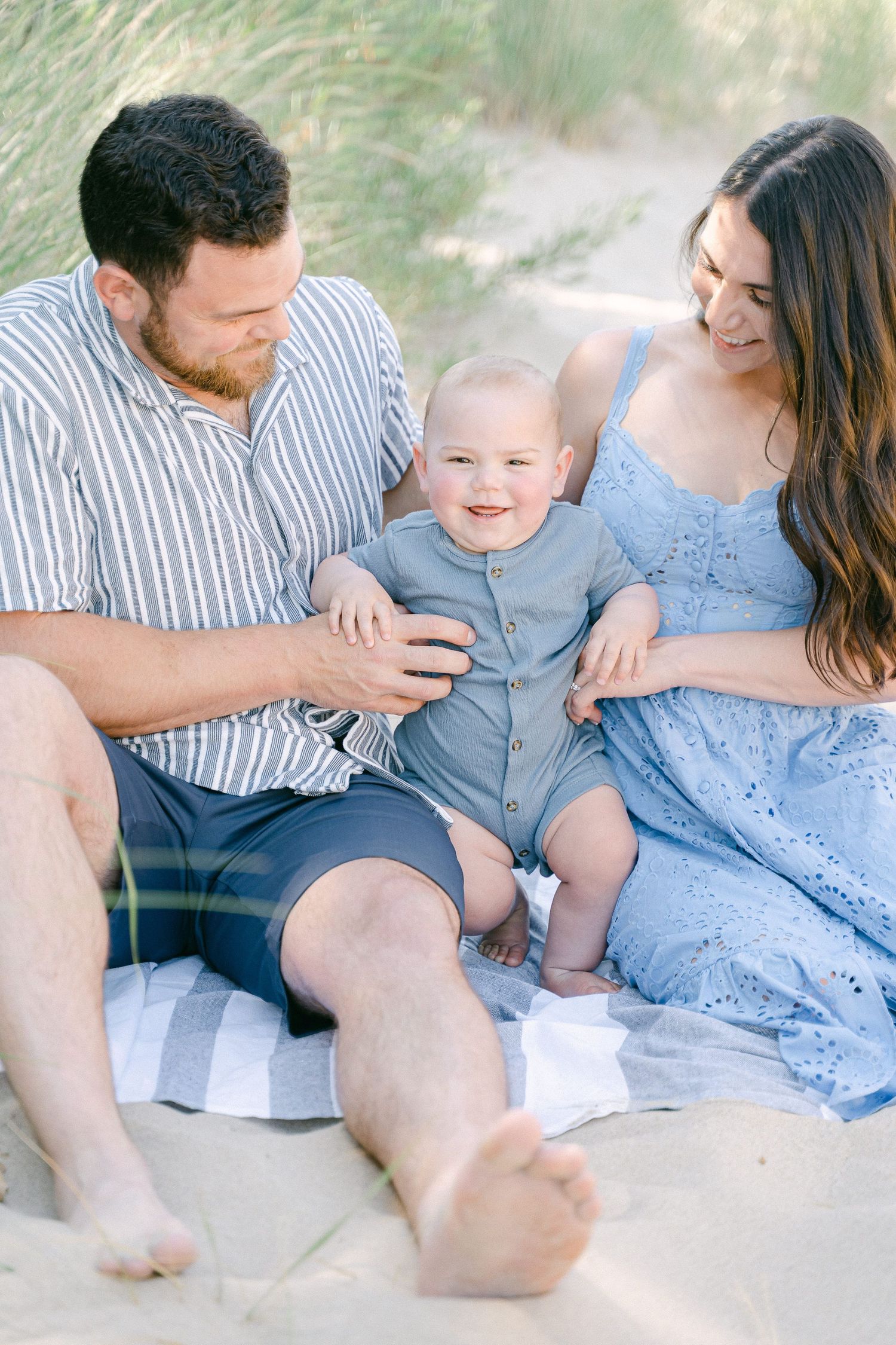 A tender family moment captured in a series of intimate beach photos showing playful interactions.