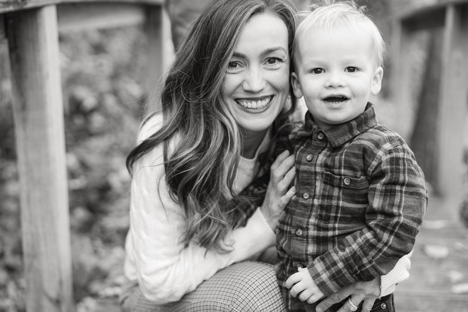 Black and white photo series showing a couple and child in casual outfits posing outdoors in a natural setting.
