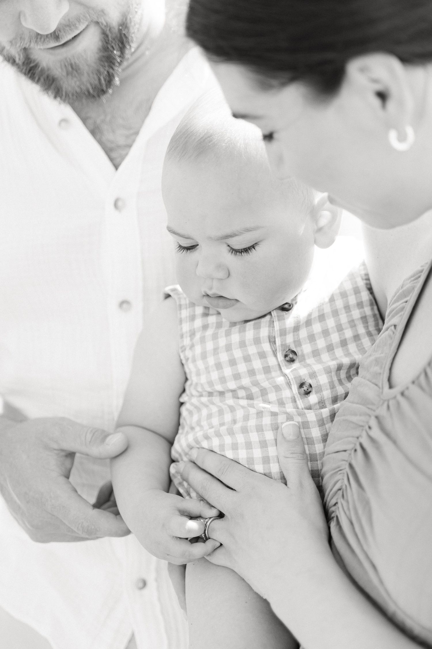 Black and white intimate family portraits showing gentle moments and tender interactions.