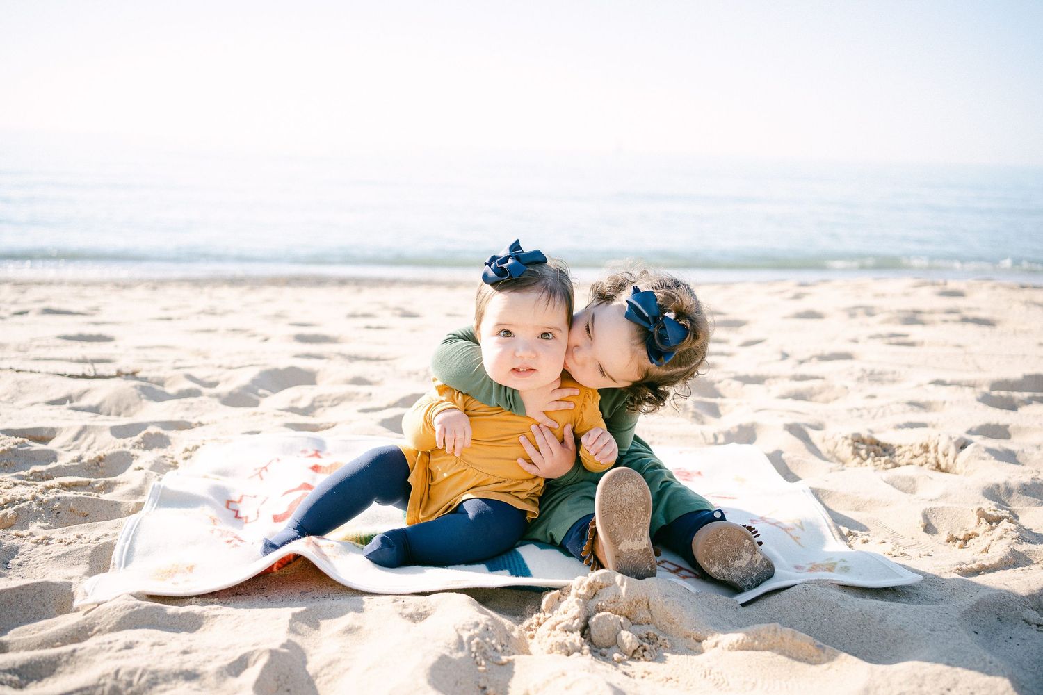 A series of beach photos showing someone relaxing and lounging on sandy shores with ocean views in the background.